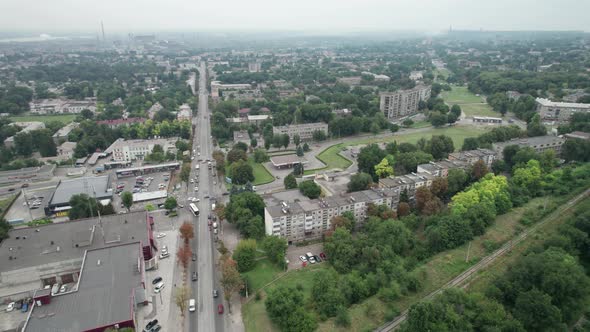 Aerial View of a Small Town Urban Landscape Flying By Houses Near Green Spaces