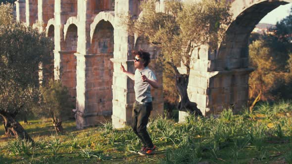 Young strong lean fit man skipping fitness cardio within nature SLOW MOTION