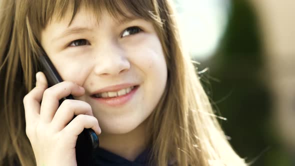 Portrait of Pretty Child Girl with Long Hair Talking on Cell Phone