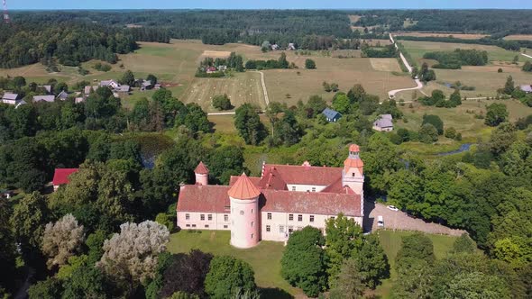 Edole Castle Manor and Old Village With Lake in Latvia, Aerial Shot From Above.