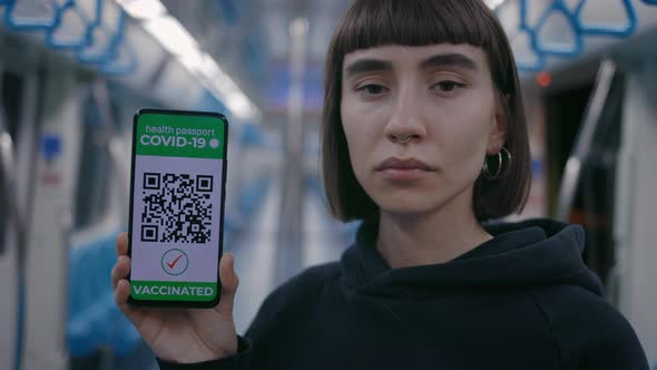 Woman Holding Smartphone with Health Passport on Screen