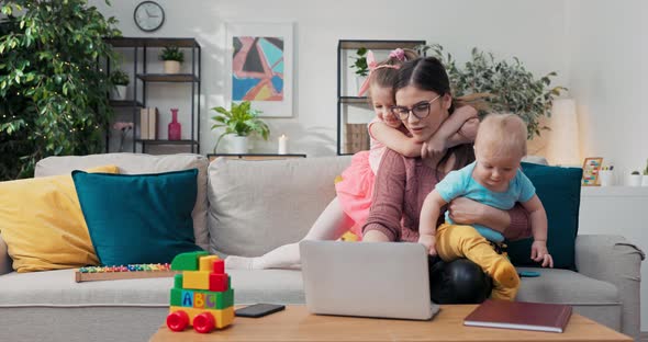 Mother Working with Baby on Lap at Home