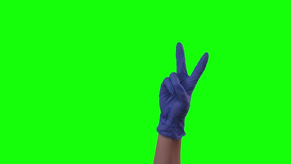 Doctors Female Hand in Blue Glove Shows Two Fingers Victory Sign, Green Screen