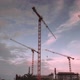 Construction site at night Time Lapse. Working tower cranes, buildings and traffic - VideoHive Item for Sale