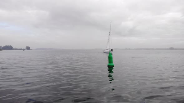 Dutch sailings yacht sails navigate on the right side of the buoys. Drone truck shot crossing the ve