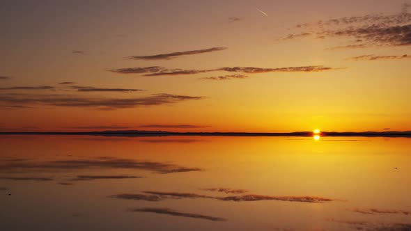 Sun rising over the horizon reflecting the sky at the Great Salt Lake