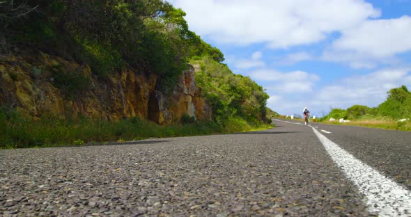 Female cyclist cycling on a countryside road