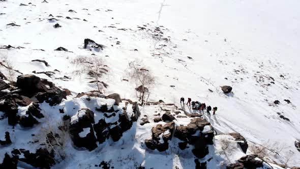 climbers are on high snow one after another, along the mountain covered with snow. aerial view bird'