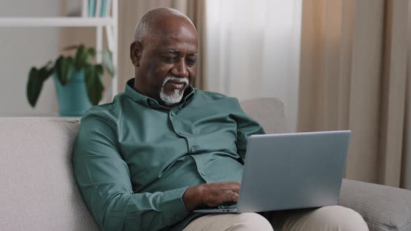 Older Bald African American Man 60s Senior Mature Businessman Use Easy Wireless Technology for