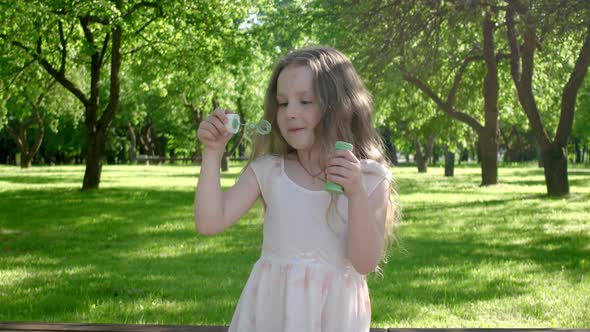 Close up of little girl kid playing with soap sud.