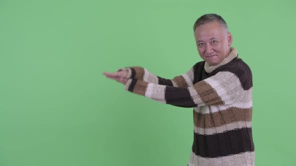 Happy Mature Japanese Man Snapping Fingers and Showing Something