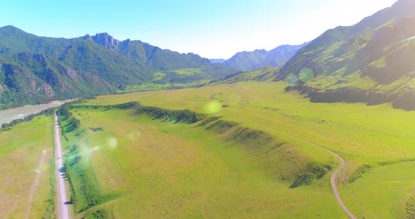 Aerial Rural Mountain Road and Meadow at Sunny Summer Morning