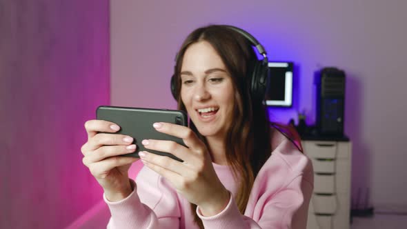 Woman Play Game with Smartphone Female Wining and Show Gesture Yes