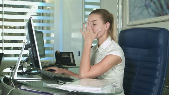 Portrait of Young Unhappy Business Woman at Desk in Office