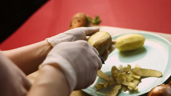 The Cook Peels the Potatoes in Very Pleasant Atmosphere