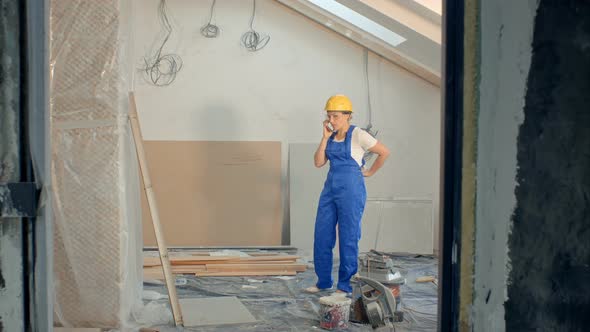 Woman Builder On Site Using Mobile Phone