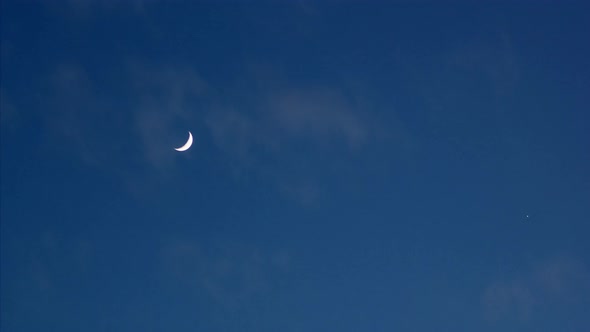 Time Lapse of a Crescent Moon at Night After Sunset