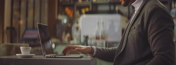 Businessman using laptop in cafe