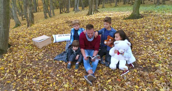 Happy Family Enjoying Autumn Day in Forest