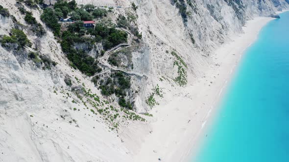 Drone view of scenic beach with white sand and turquoise sea, Greek islands.