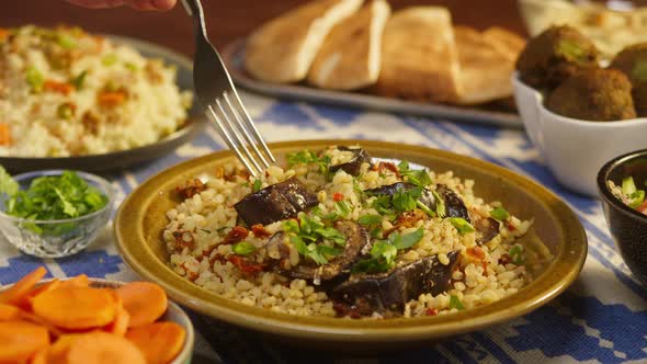 Eating Greenery on Bulgur with Eggplant Closeup Couscous with Meat on Background