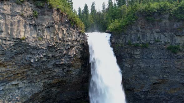 Beautiful water fall through cliff on a sunny day 4k