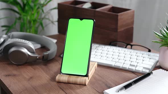 Smartphone with Green Screen on a Desk