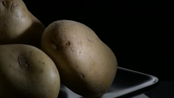 Potatoes Vegetables in a Mountain Gyrating on a Black Tray