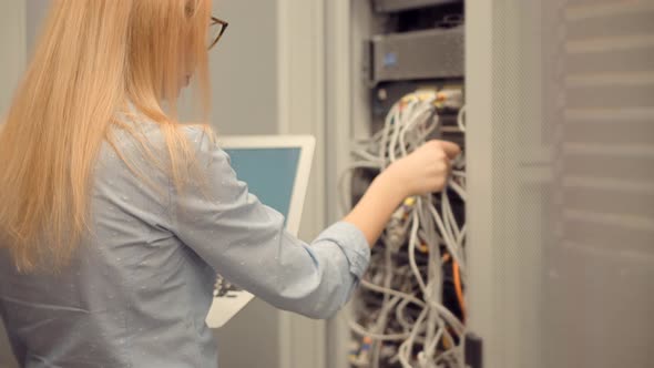 Woman Blockchain Diagnostic Network Engineer In Server Room Mining Farm.