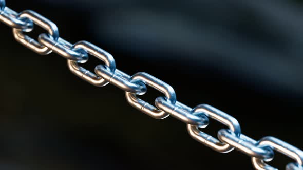 A metal chain is blown to pieces. Breaks chains. Regains freedom. Break free.