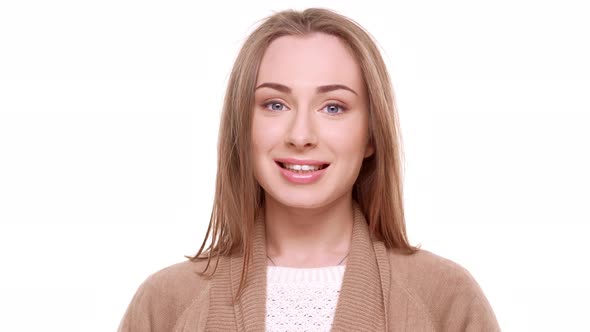 Confused Caucasian Young Female with Light Brown Hair Standing Shy on White Background