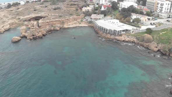 A restaurant at coastline of Kyrenia, Cyprus - Aerial Drone View 4K