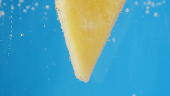 Pineapple Slice in Carbonated Water Sweet Cocktail Cold Lemonade with Ananas Ripe Fruits on Blue