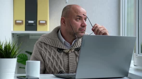 Middle Aged Businessman in Eyewear Working with Computer Remotely Sitting at Home or in Office