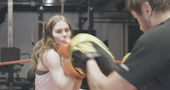 Live Camera, Confident Young Female Boxer Exercising with Coach in Gym. Portrait of Beautiful alt