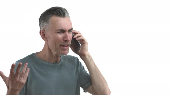 Handsome Adult Man with Grey Hair and Bristle Talking on Phone Explain Something During Conversation