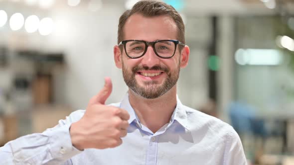 Portrait of Positive Businessman Doing Thumbs Up