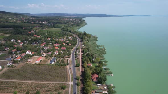 Aerial view of Lake Balaton, road, houses, fields and gardens in Hungary