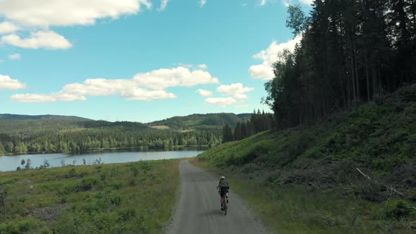 Cyclist Ride Up Beautiful Forest Gravel Road