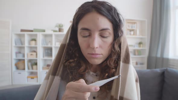 Woman Measuring Temperature Using Thermometer