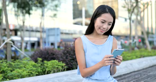 Woman use of smart phone in city 