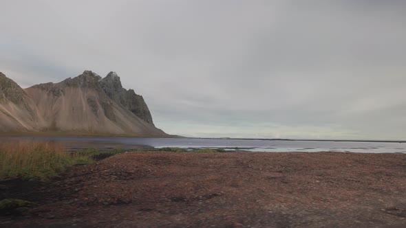 View From a Moving Car Window of a River and Mountains in Iceland