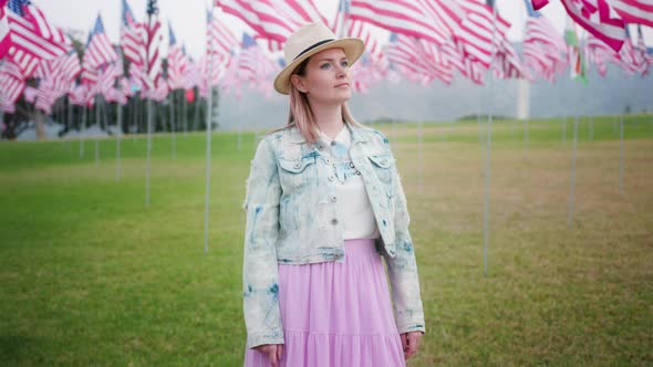 Young Attractive Woman Enjoying Evening in Memorial Park with American Flags