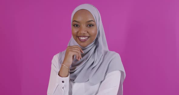 Portrait of Young Modern Muslim Afro Beauty Wearing Traditional Islamic Clothes on Plastic Pink