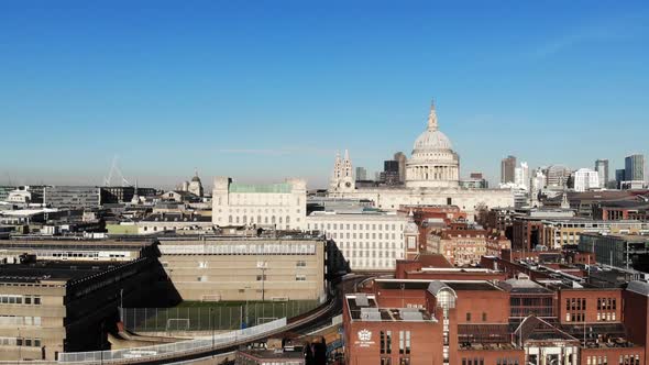 Reverse aerial shot of City of London School and St Pauls Cathedral on a sunny day