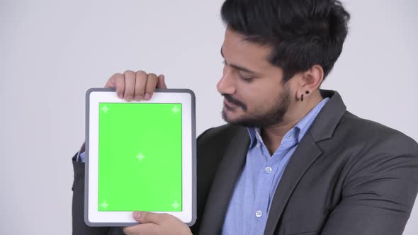 Young Happy Bearded Indian Businessman Showing Digital Tablet