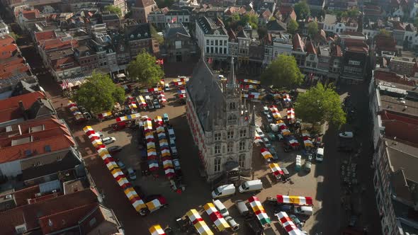 Aerial View Of Gouda's 15th Century Town Hall With Market In Gouda, Netherlands. - ascend