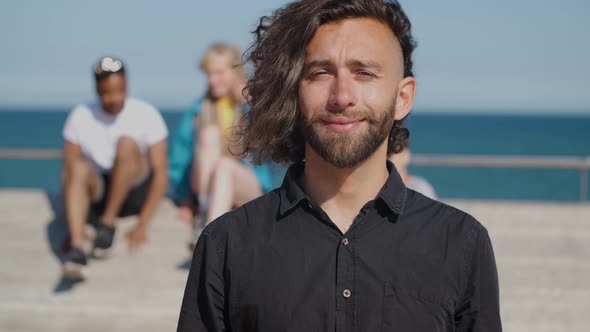 Young Stylish Man in Sunlight on Seafront