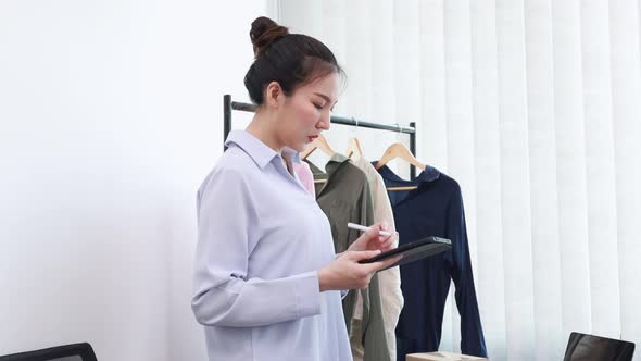 Asian woman selling clothes online