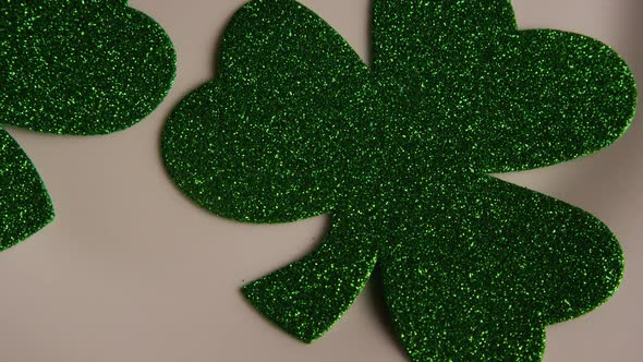 Rotating stock footage shot of St Patty's Day clovers on a white surface - ST PATTYS 003